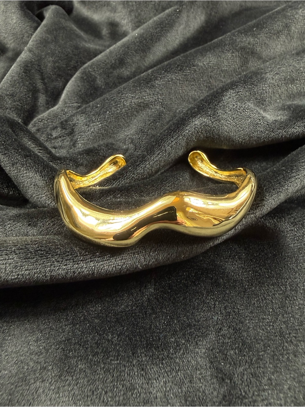 Gold tone Wavy Cuff Bracelet.